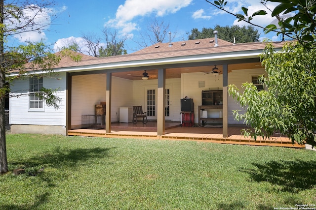 back of house featuring a yard, ceiling fan, and a deck