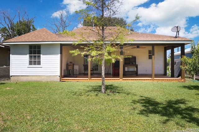 rear view of property featuring a yard, ceiling fan, and a patio