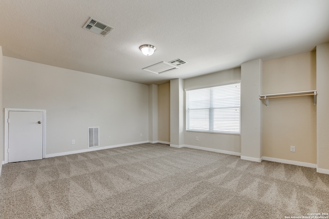 carpeted spare room featuring a textured ceiling