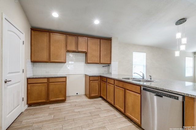 kitchen featuring light hardwood / wood-style floors, dishwasher, sink, and plenty of natural light