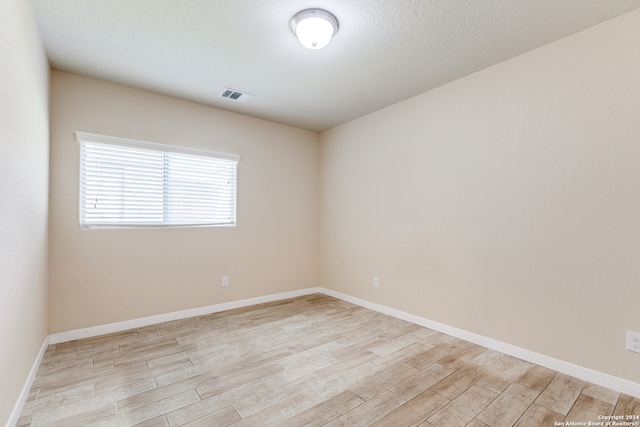 unfurnished room featuring light hardwood / wood-style flooring