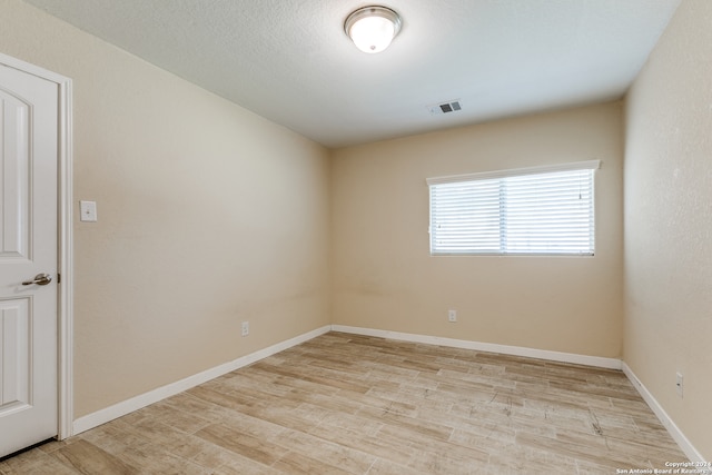 unfurnished room featuring light hardwood / wood-style floors