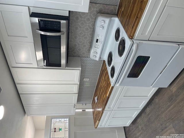 kitchen featuring oven and white cabinetry