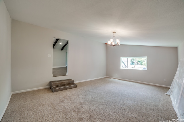 spare room with light carpet, a notable chandelier, and vaulted ceiling