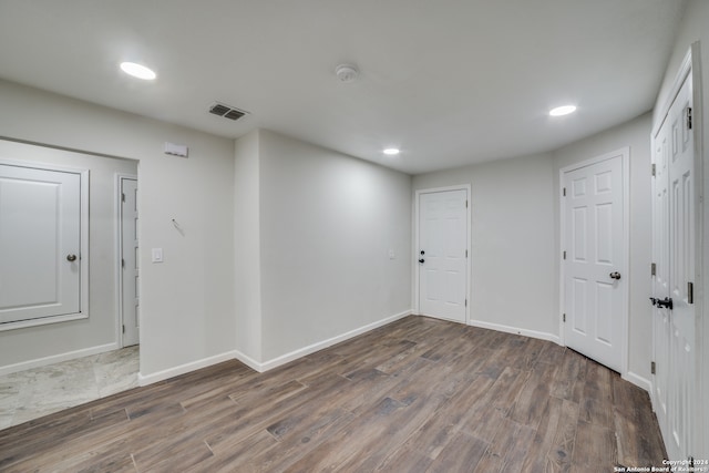 empty room with dark hardwood / wood-style flooring