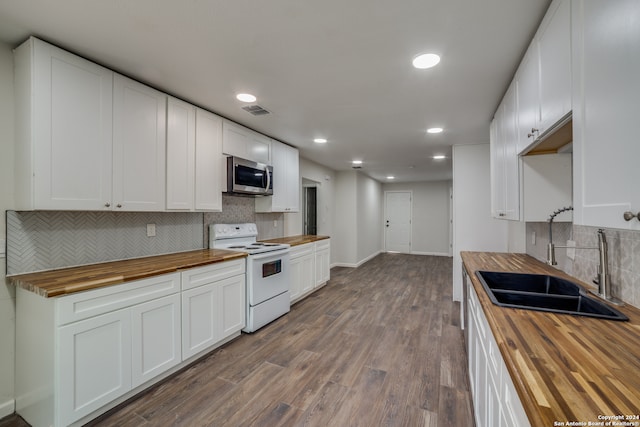 kitchen with white cabinets, sink, white electric stove, and wood counters