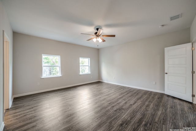 unfurnished room with ceiling fan and dark hardwood / wood-style flooring