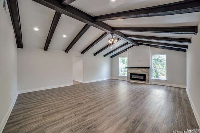 unfurnished living room featuring vaulted ceiling with beams, hardwood / wood-style floors, a chandelier, and a fireplace