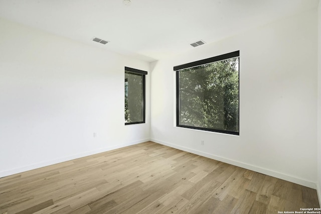 unfurnished room with light wood-type flooring