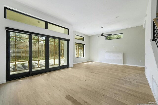 empty room with ceiling fan and light wood-type flooring