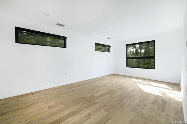 spare room featuring light wood-type flooring