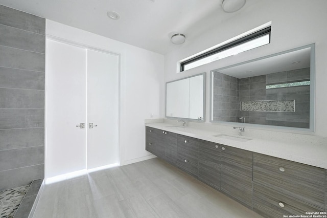 bathroom featuring a tile shower and vanity