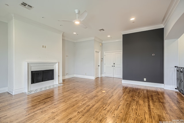 unfurnished living room featuring light hardwood / wood-style flooring, ceiling fan, and crown molding