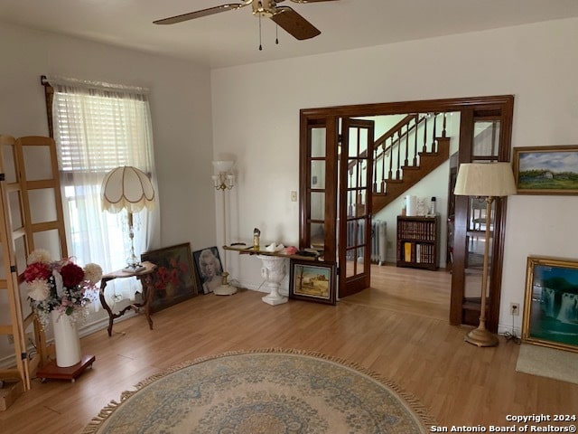 interior space with wood-type flooring, radiator heating unit, and ceiling fan