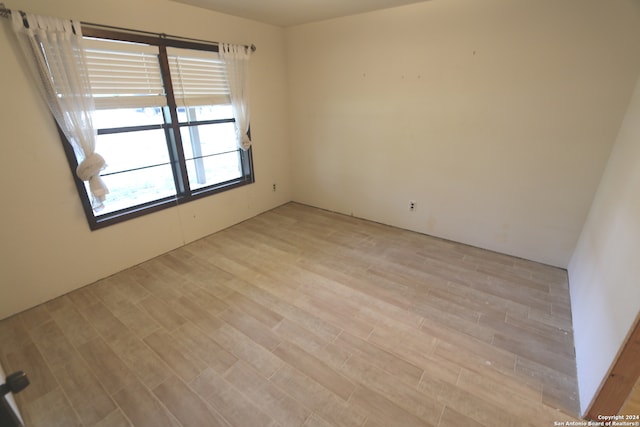 empty room with light hardwood / wood-style floors