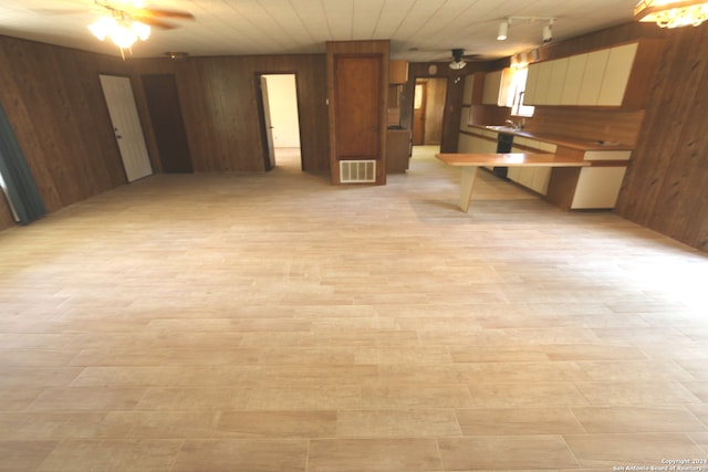 interior space with ceiling fan, wooden walls, light hardwood / wood-style flooring, track lighting, and wooden ceiling