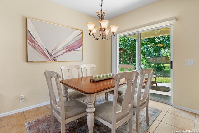 tiled dining area featuring a chandelier