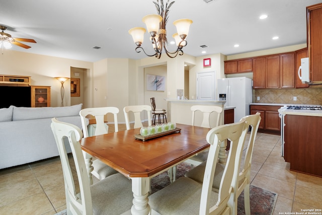 dining area with ceiling fan with notable chandelier and light tile patterned flooring