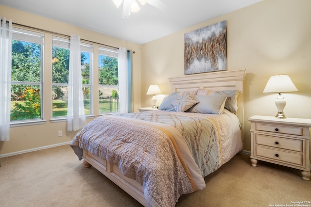 bedroom with ceiling fan and light colored carpet