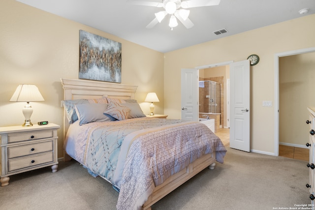 bedroom featuring ensuite bath, ceiling fan, and carpet flooring