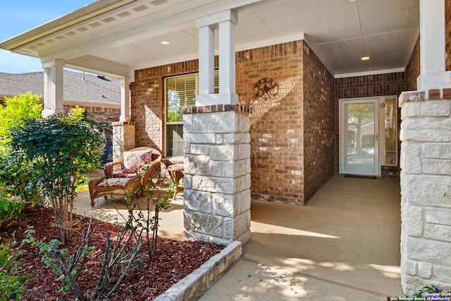 view of exterior entry featuring covered porch