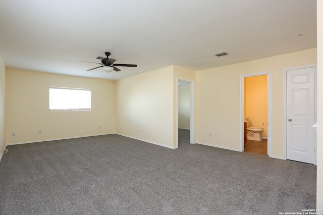 interior space featuring dark colored carpet and ceiling fan