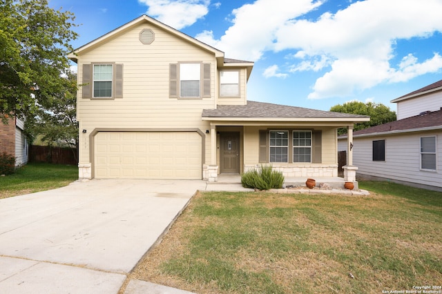 view of front of home featuring a front lawn, a porch, and a garage