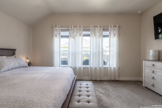 carpeted bedroom with lofted ceiling