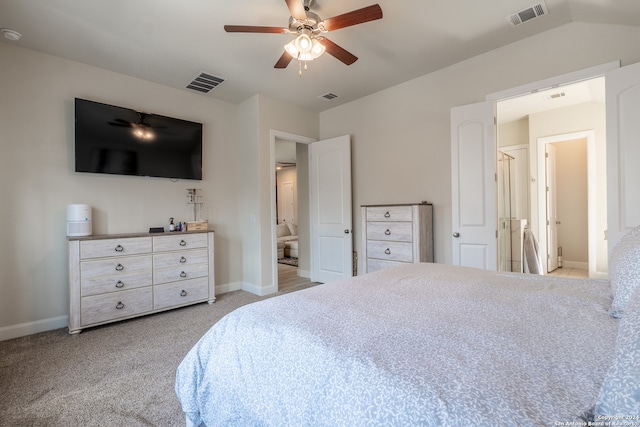 carpeted bedroom featuring connected bathroom, vaulted ceiling, and ceiling fan