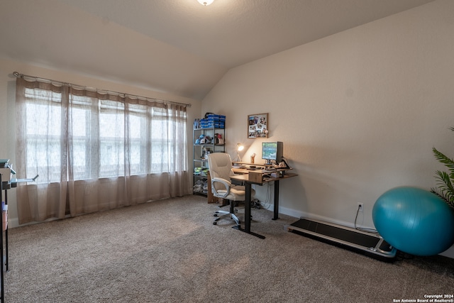 office area with vaulted ceiling and carpet flooring