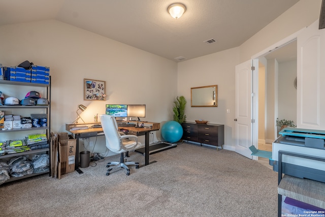 office with light carpet and vaulted ceiling