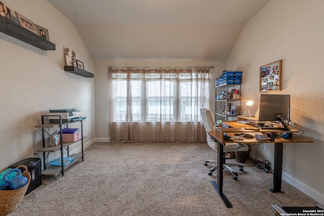 carpeted office with lofted ceiling