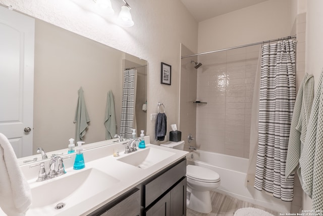 full bathroom featuring shower / bath combination with curtain, hardwood / wood-style flooring, vanity, and toilet