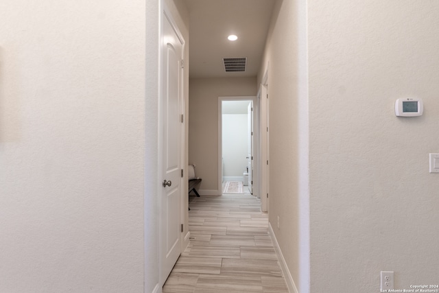 hall with light hardwood / wood-style floors