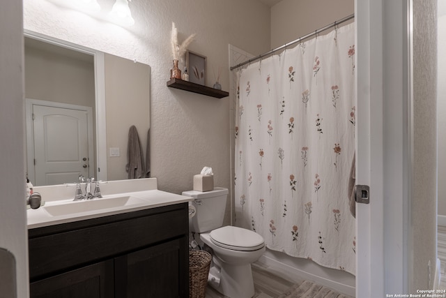 bathroom with wood-type flooring, vanity, and toilet