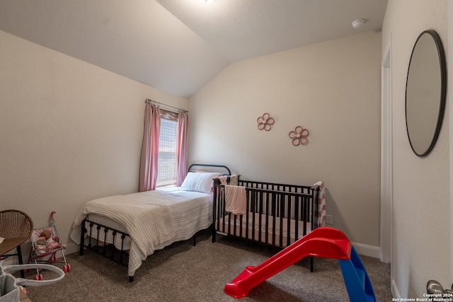 carpeted bedroom with lofted ceiling