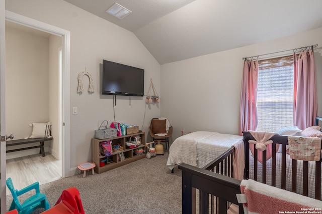 carpeted bedroom featuring vaulted ceiling