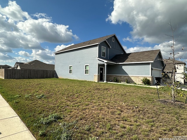 view of home's exterior with a lawn and a garage