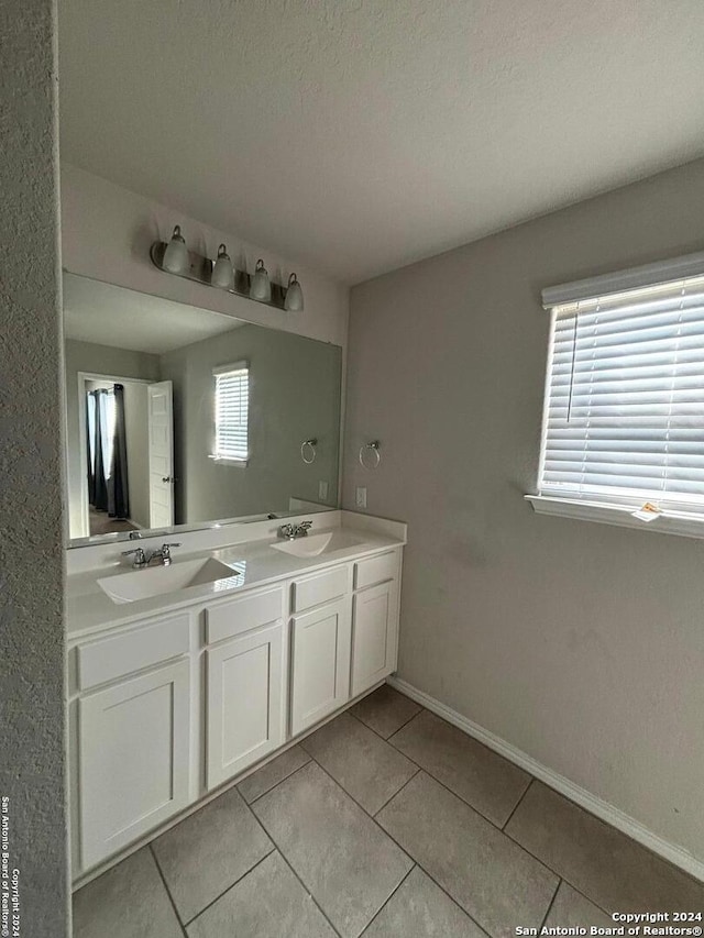 bathroom featuring vanity, a textured ceiling, and tile patterned floors