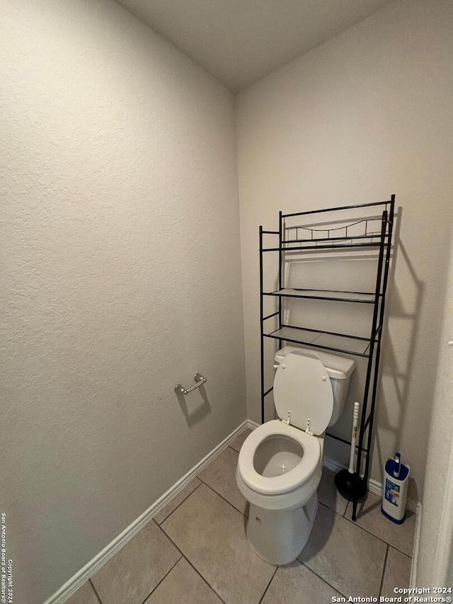 bathroom featuring tile patterned flooring and toilet