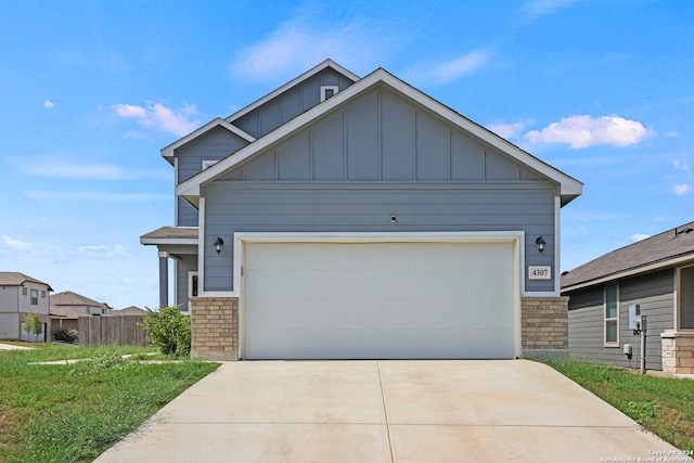 craftsman house with a front yard and a garage