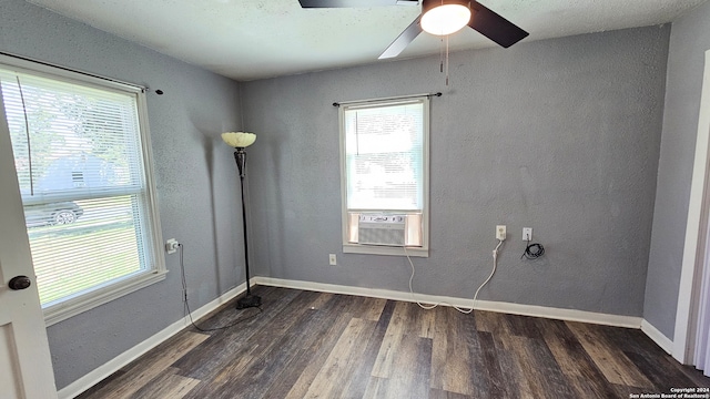 unfurnished room featuring cooling unit, dark hardwood / wood-style flooring, and ceiling fan