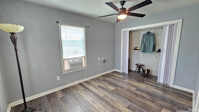 unfurnished bedroom featuring ceiling fan, cooling unit, a closet, and dark hardwood / wood-style floors