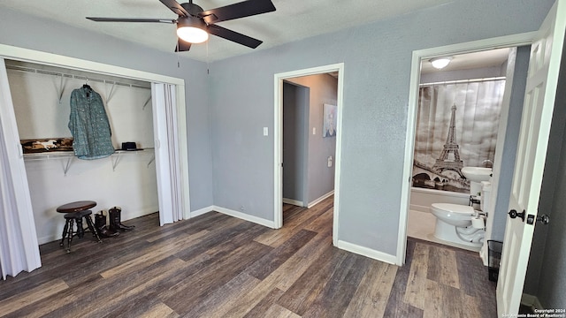 bedroom with a closet, connected bathroom, ceiling fan, and dark hardwood / wood-style flooring