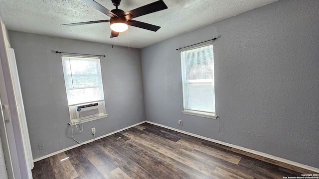 unfurnished room featuring a textured ceiling, cooling unit, dark hardwood / wood-style flooring, and ceiling fan