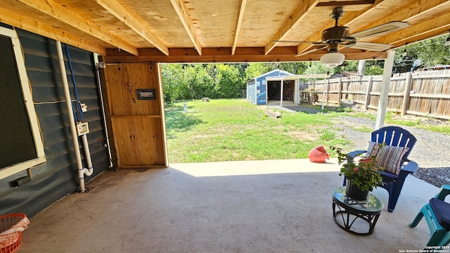 view of patio featuring a storage shed and ceiling fan