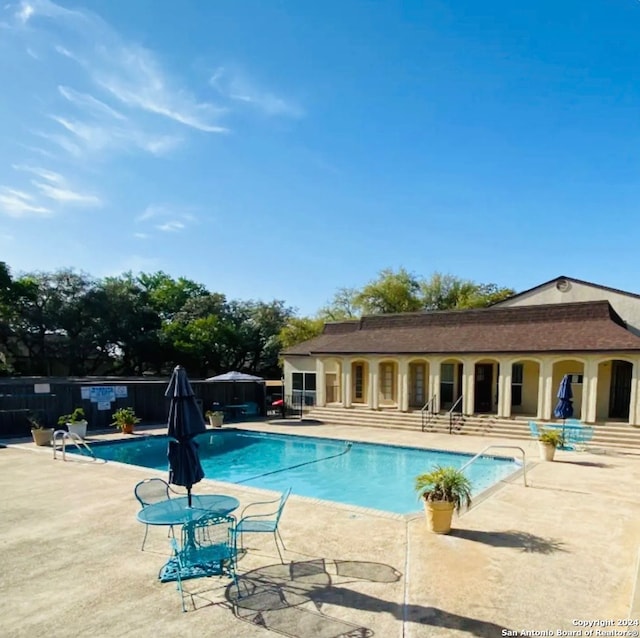 view of swimming pool with a patio area