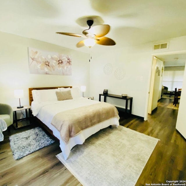 bedroom with ceiling fan and dark wood-type flooring