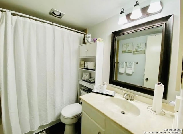 bathroom with toilet and vanity