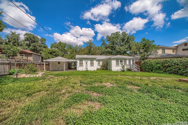 rear view of house with a lawn